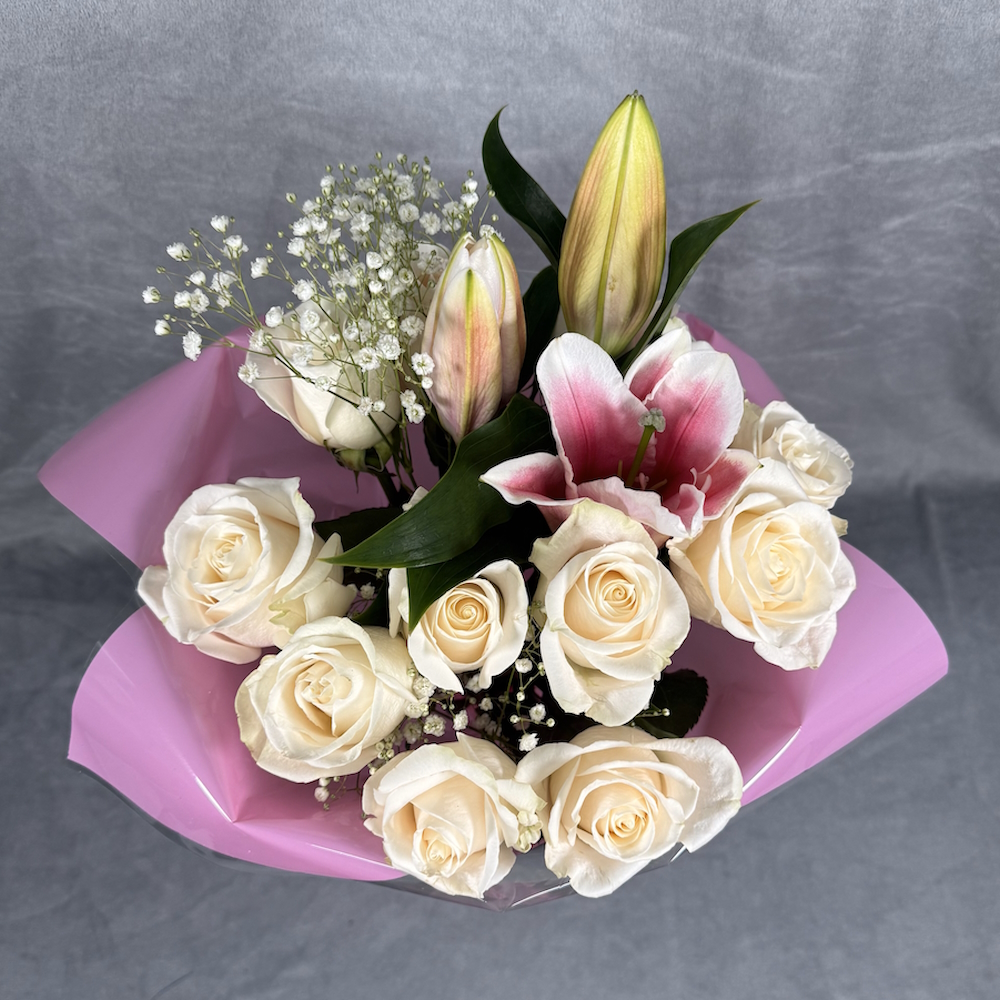 peach roses pink lilies bouquet with glass vase